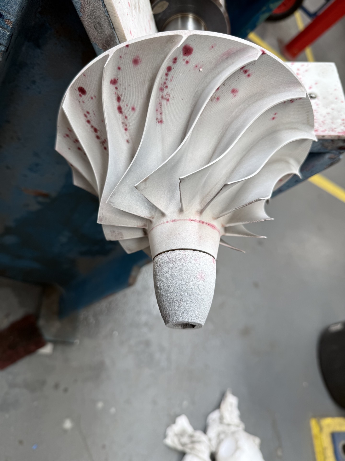 Dye penetrant inspection indications on a machined impeller